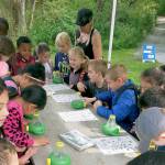 Federal Way students use bug viewers to look at macroinvertebrates a Storming the Sound with Salmon Release event, last year. The public is invited to attend this year&rsquo;s educational events, from 10:30 a.m. to 12:30 p.m., May 10-12 and May 18 at West Hylebos Wetlands Park. During the event, salmon, raised by students, will be released into Hylebos Creek. Contributed photo