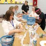 Teachers, students and volunteers helped homeless students Wednesday at Sacajawea Middle School by making &ldquo;leis&rdquo; stuffed with toothpaste, shampoo and soap. Betty Taylor, the event&rsquo;s organizer, has raised more than $600 to help the homeless community through these lei-making events. RAECHEL DAWSON, Marcie Shannon graphic below, the Mirror