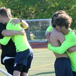 Beamer coach Joel Lindberg and senior Austin Stafford (left) embrace one another moments after the Titans defeated the Pasco Bulldogs 2-1 to win the school&rsquo;s first state title in any sport. JEROD YOUNG, the Mirror