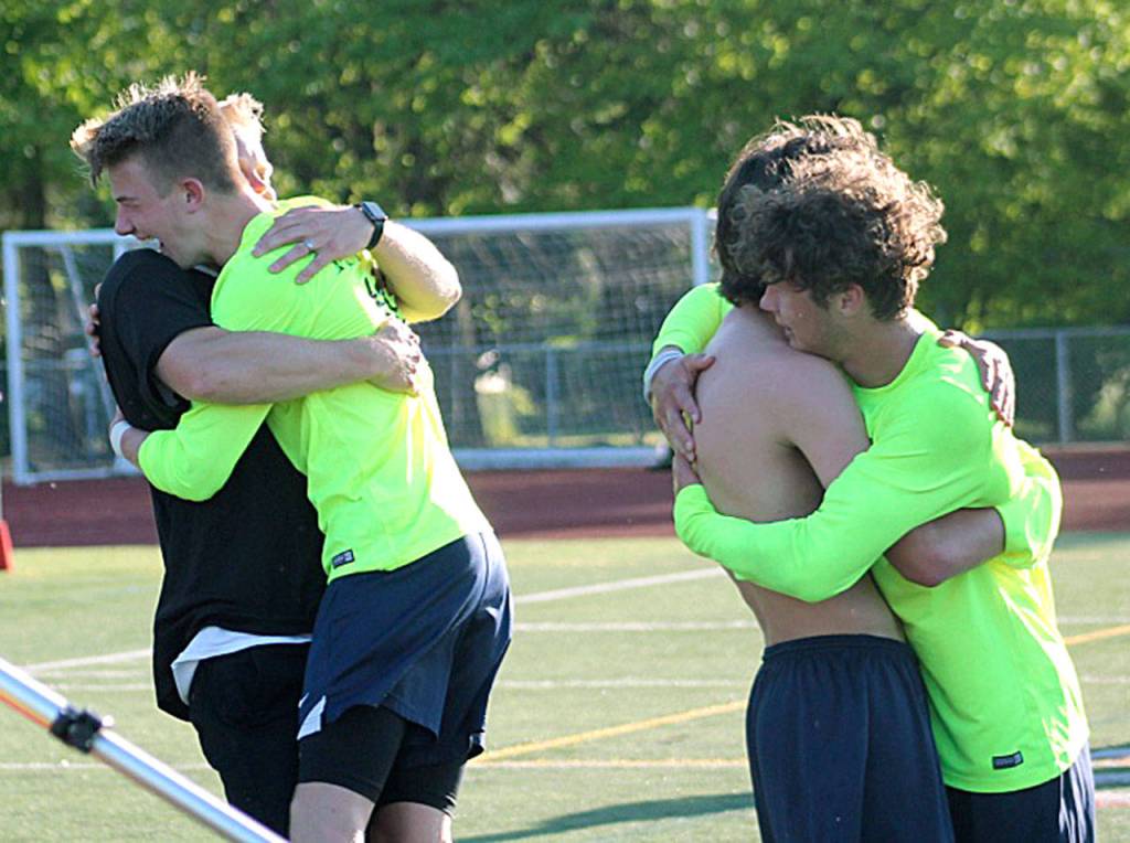 Beamer coach Joel Lindberg and senior Austin Stafford (left) embrace one another moments after the Titans defeated the Pasco Bulldogs 2-1 to win the school&rsquo;s first state title in any sport. JEROD YOUNG, the Mirror