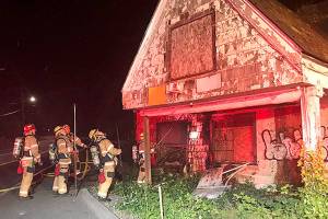 Firefighters battle fire at abandoned house on Military Road