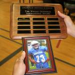 Leilani Gennings holds up a photo of her son Wesley Gennings when he played football for Saghalie Middle School. RAECHEL DAWSON, the Mirror