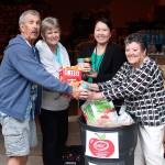 Multi-Service Center volunteers Jeff and Vivian Berfield, from left, pose with Bao Thao, the food bank program coordinator, and Terri Turner, the food and clothing bank director. The Multi-Service Center&rsquo;s Summer Meals program will feed youth under 18 years old throughout the summer at select locations in Federal Way. RAECHEL DAWSON, the Mirror