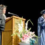 Todd Beamer High School graduate Sam Bird, front, presents her graduation speech to her classmates through sign language at the school&rsquo;s graduation ceremony June 17 as Agnes Llamas interprets. Bird, who is deaf, received a cochlear implant as a child and that, combined with a video game her father got her as a young child, spurred a lifelong interest in technology, games and computers. She will attend the Rochester Institute of Technology in New York in the fall and study computer science. Photo courtesy Federal Way Public Schools