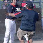 Federal Way National 10-11 All-Star Joseph Krahner, left, celebrates with a coach after scoring the game-winning run in the Federal Way Nationals&rsquo; 6-5 victory in the District 10 championship game at the Federal Way National League Complex Friday. Photo courtesy Mark Klaas