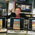 Darren Adams, president of Pristine Comics and owner of West Coast Sports Cards in Federal Way, poses with the three comic books he sold on eBay, which went for a total of $1,562,200. This was the first time these comic books were available to the public. &ldquo;All Star Comics #8&rdquo; sold for $936,223, the highest of the three. It features Wonder Woman&rsquo;s first ever appearance. Courtesy Darren Adams.