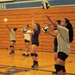Federal Way Eagles volleyball players practice serving at a practice last week. The Eagles are returning four seniors, who will play an important role leading the offense and defense on the court, as well as mentoring the younger players. JESSICA KELLER, the Mirror