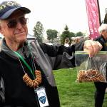 Federal Way Symphony volunteer Bob Kellogg sells pretzel necklaces at the Blues Festival held Sept. 16 at Town Square Park.