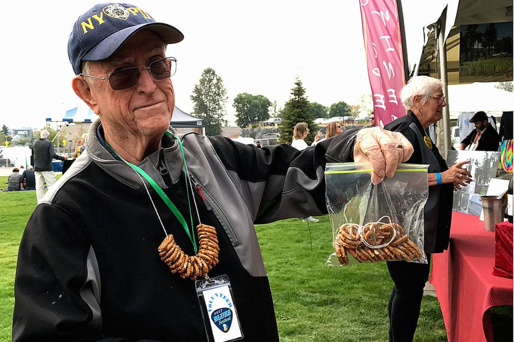 Federal Way Symphony volunteer Bob Kellogg sells pretzel necklaces at the Blues Festival held Sept. 16 at Town Square Park.