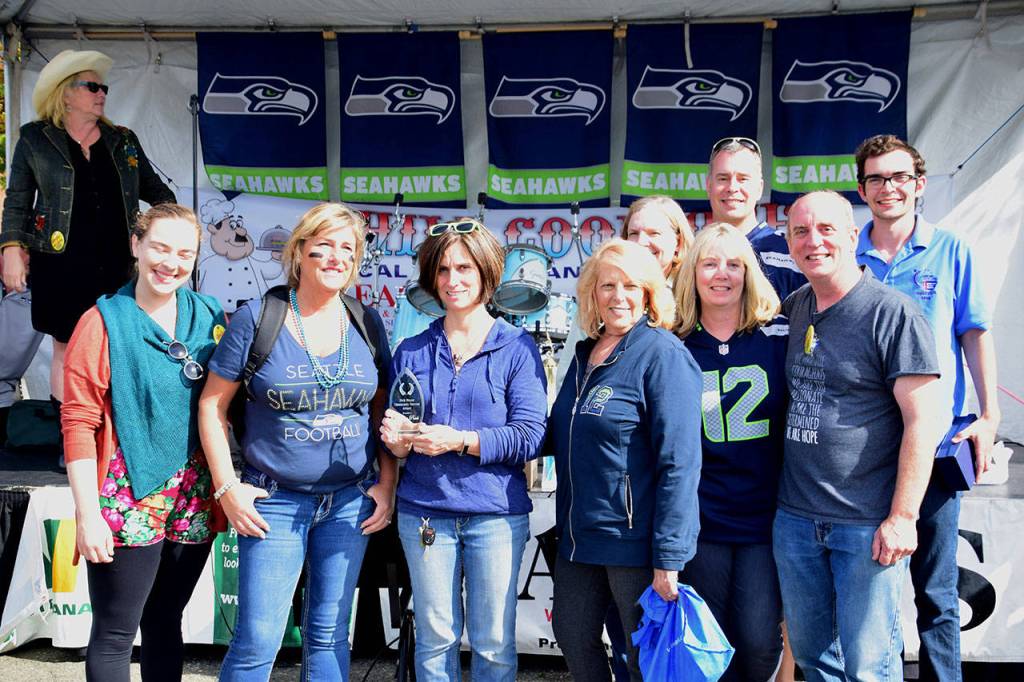 Shelley Pauls (center) received the Dick Mayer Community Service Award at the Federal Way Farmers Market&rsquo;s Chili Cook-off. Photo courtesy of Bruce Honda
