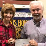 Howard Montoure, a Pacific Northwest Kiwanis Foundation board member, presents a check to Kiwanis Club of Greater Federal Way member Marie Sciacqua, who submitted the grant request. Contributed photo
