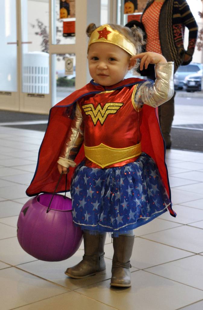 Nina Brown, 16 months, pauses from trick-or-treating while dressed as Wonder Woman. HEIDI SANDERS, the Mirror