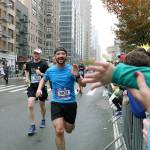 Travis Bjork, a 2010 Federal Way High School graduate, reaches out to high five his 3-year-old nephew Jacksons hand while running in the New York City Marathon Nov. 5. Courtesy Travis Bjork