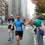 Travis Bjork, a 2010 Federal Way High School graduate, reaches out to high five his 3-year-old nephew Jacksons hand while running in the New York City Marathon Nov. 5. Courtesy Travis Bjork