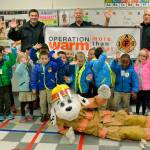 SKFR firefighters present young Mirror Lake students with coats for winter