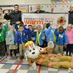 SKFR firefighters present young Mirror Lake students with coats for winter