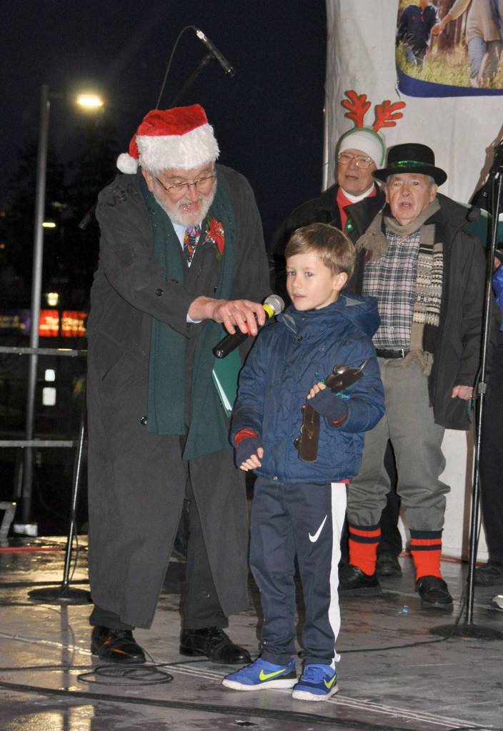 Six-year-old Connor Ross helps the Harmony Kings sing Jingle Bells during the annual tree lighting ceremony. Heidi Sanders, the Mirror