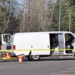 A police officer works at the scene of a shooting in the parking lot behind the King County Aquatic Center in Federal Way on Wednesday morning. Two 17-year-olds were transported to Harborview Medical Center with serious injuries. Heidi Sanders, the Mirror