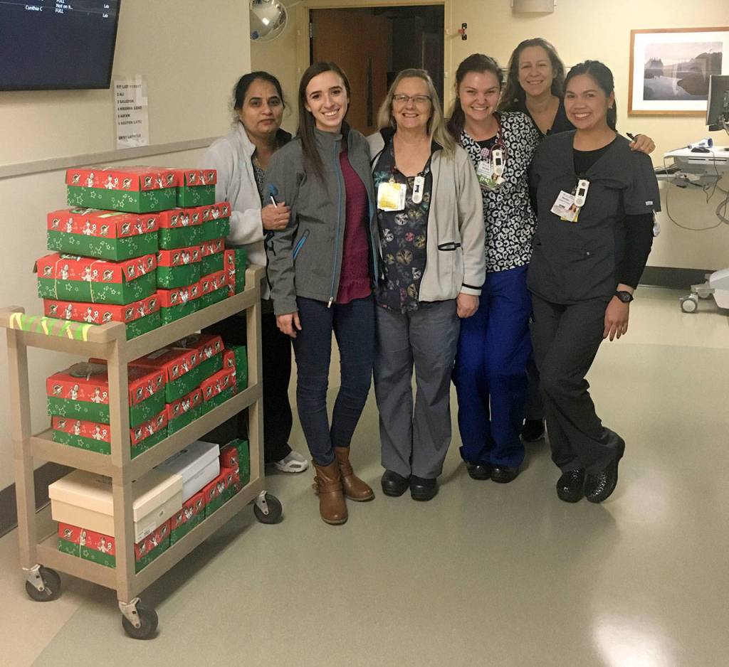 Olesea Ialanji, second from left, and her co-workers at St. Francis Hospital filled shoeboxes for Operation Christmas Child this year. Ialanji, who is a nurse at the hospital, received an Operation Christmas Child shoebox while living in Moldova. Courtesy Olesea Ialanji