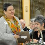Christina Portillo, who volunteers at the Federal Way Day Center, passes around a clipboard to get more people to help at the center. Heidi Sanders, the Mirror