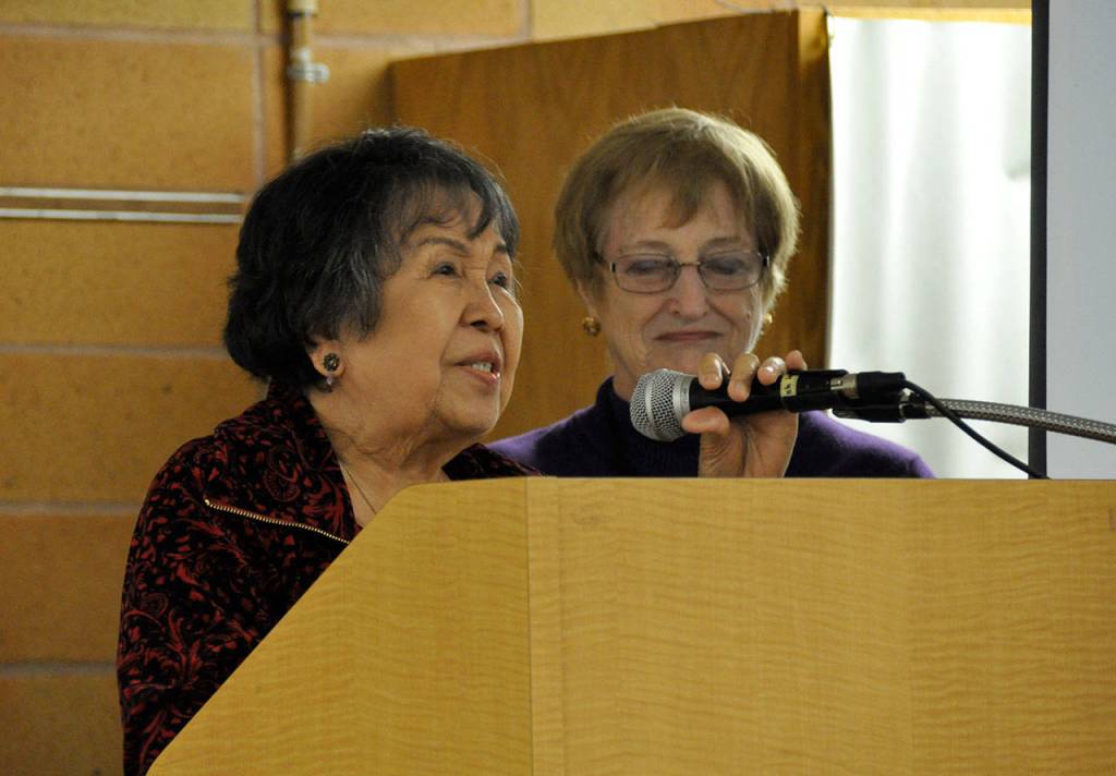 Rufina Jordan, left, who has volunteered more than 700 hours at the Federal Way Day Center, receives recognition for her service during the centers first anniversary celebration. Heidi Sanders, the Mirror