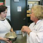 Federal Way High School junior Connor McConnaughey speaks to Foundation of Culinary Arts teacher Sherry Kerr about a holiday recipe students were making in class before winter break. McConnaughey wants to pursue a career as a pastry chef and intends to take Kerrs ProStart Culinary Arts Program class, which is a career and technical education program offered at Federal Way and Thomas Jefferson high schools. JESSICA KELLER, the Mirror