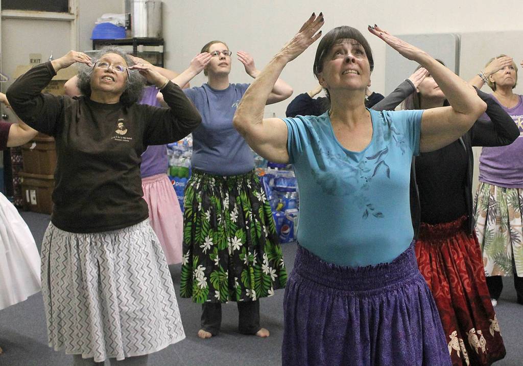 Tish Pinho, front right, and Cynthia Mann, left, perform a Hawaiian dance with other members of the Federal Way hula school at an evening practice. The hulaus kumu, or teacher, Kamaile Hamada not only teaches ancient and modern hula dances, he also teaches other aspects of the Hawaiian culture at his school. JESSICA KELLER, the Mirror
