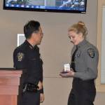 Federal Way Police Chief Andy Hwang, left, presents Anna Murphy with the Police Chiefs Commendation Medal for her work as a Police Explorer. Heidi Sanders, the Mirror
