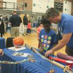 Rainier Elementary School fifth-grade teacher Glyn Jenkins and a couple of his students assemble the different pieces of their Rube Goldberg Machine they tested at the FWPS second annual STEM Exploration Night Wednesday, March 28, at Todd Beamer High School. Jessica Keller, the Mirrror