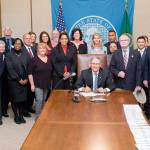 Gov. Jay Inslee on March 21 signs into a law House Bill 2009, allows family members of armed forces members, veterans and active duty National Guard members lost or seriously disabled during service to receive a $500 textbook stipend to help cover the cost of books while pursuing higher education. State Rep. Kristine Reeves, D-Federal Way, sponsored the legislation. Courtesy Washington State LSS