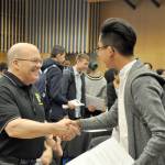 Art Stokes, director of recruitment and retention for the South King County Soccer Referee Association, left, shakes hand with Eden Mai, a senior at Thomas Jefferson High School, during a job fair at Todd Beamer on Wednesday. HEIDI SANDERS, the Mirror