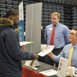 Shamaun Guiden, a sophomore a Decatur High School, left, gets employment information from DJ Pelphs, center, and Bruce Johnson, of Chick-Fil-A. HEIDI SANDERS, the Mirror