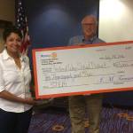 In this 2016 file photo, Roger Hunt presents a check for $10,000 to Federal Way Public Schools Superintendent Tammy Campbell.