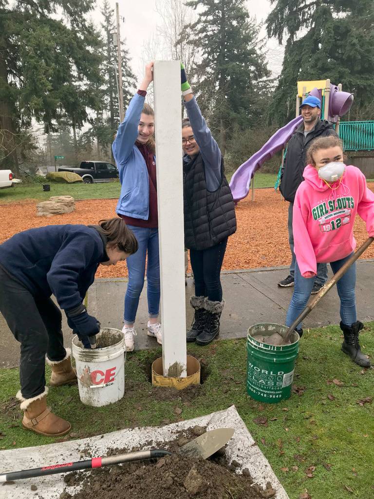 From left, Mia Rapp, Alyssa Cleveland, Hanna Banks and Halle Banks mix cement and stabilize the pole for the book house. Courtesy Catherine Banks                                From left, Mia Rapp, Alyssa Cleveland, Hanna Banks and Halle Banks mix cement and stabilize the pole for the book house. Courtesy Catherine Banks