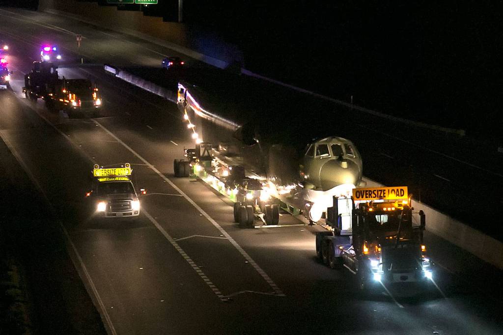 The B-52 Midnight Express is towed along Highway 525 from Paine Field en route to Boeing Field in Seattle early Sunday morning. (Kevin Clark / The Herald)