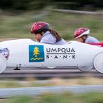 Amelia Allen (left) looks down at the track as she races another driver in unweighted practice soap box derby cars June 7 on Camano Island. The 11th Stanwood-Camano Soap Box Derby takes place Saturday. (Andy Bronson / The Herald)