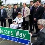 Local dignitaries and community members show off a new street sign for Veterans Way, which will be the new name of South 320th Street, during the June 16 Flag Celebration Program at The Commons mall parking lot. Mirror staff photo