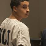 Giovanni D. Herrin glances back during his arraignment in King County Superior Court at the Maleng Regional Justice Center on Tuesday. Herrin pleaded not to a first-degree murder charge and to a second-degree escape charge. MARK KLAAS, Kent Reporter