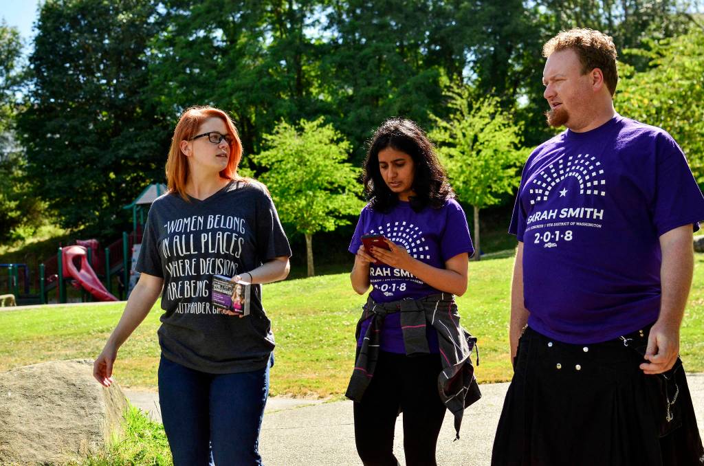 Sarah Smith walks with campaign volunteers Supreet Kaur and Fern Zimmerman to canvas apartments in the New Holly neighborhood in Southeast Seattle on July 7.                                Photo by Josh Kelety