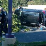 Kent Police investigate the scene of a July 25 crash that killed a pedestrian on Pacific Highway South. The driver of the vehicle who struck the pedestrian also hit a tree and another car before landing on its side. COURTESY PHOTO