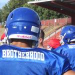 The Federal Way High School football team wears practice jerseys with the word brotherhood on the back to honor former teammate Allen Harris. Photo by Olivia Sullivan, the Mirror