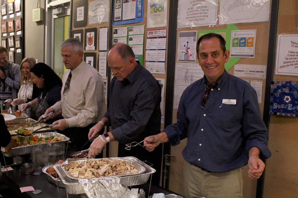 Mark Hendricks, executive director of the Federal Way Boys & Girls Club, all smiles while serving Thanksgiving dinners. Olivia Sullivan/staff photo