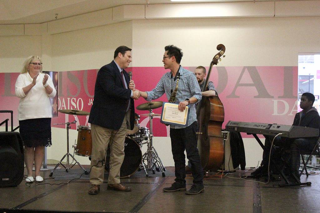 Mayor Jim Ferrell presented a certificate of recognition to Jeff Chang, the Decatur Jazz Band director, for the bands recent trip to perform in Taiwan. Olivia Sullivan/staff photo