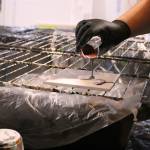 Darlene LeMaster demonstrates the paint pouring after mixing blue, purple, and copper colors together. Olivia Sullivan/staff photo