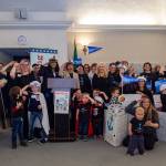 Wearing sailor hats and anchor shirts, a group of moms and kids salute Rep. Christine Reeves new childcare bill she introduced on Jan. 16 in Olympia. Photo courtesy of MomsRising.org