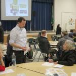 Aaron Winston from McGranahan Architects, center, discusses the proposed design for the new Totem Middle School and Star Lake Elementary School project with community members at a Jan. 16 bond meeting held at Totem Middle School. Olivia Sullivan/staff photo