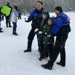 Kids and adults brought their sleds to Celebration Park and mingled with Federal Way police as the snow drifted down Monday afternoon. Photo by Andy Hobbs/the Mirror