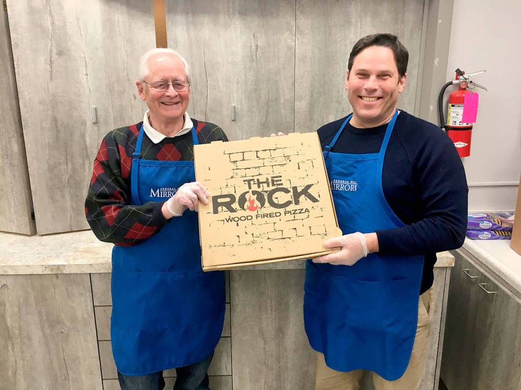 Bob Roegner, left, and Mayor Jim Ferrell volunteer at a homeless shelter Monday night. Olivia Sullivan/staff photo