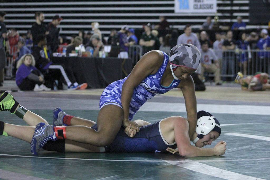 Federal Way senior Anjilia Sumandig restrains Arlingtons Tailer Cochran during the state wrestling quarterfinals. Sumandig ended up placing third in state. Olivia Sullivan/staff photo