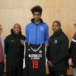 Jaden McDaniels, center, stands with, from left, FWHS principal Dr. Matt Oberst, FWHS boys basketball interim head coach Yattah Reed, and assistant coaches Quinn Gillis and Doug Sloane. Olivia Sullivan/staff photo